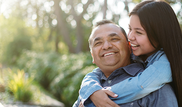 Father and daughter embracing outdoors